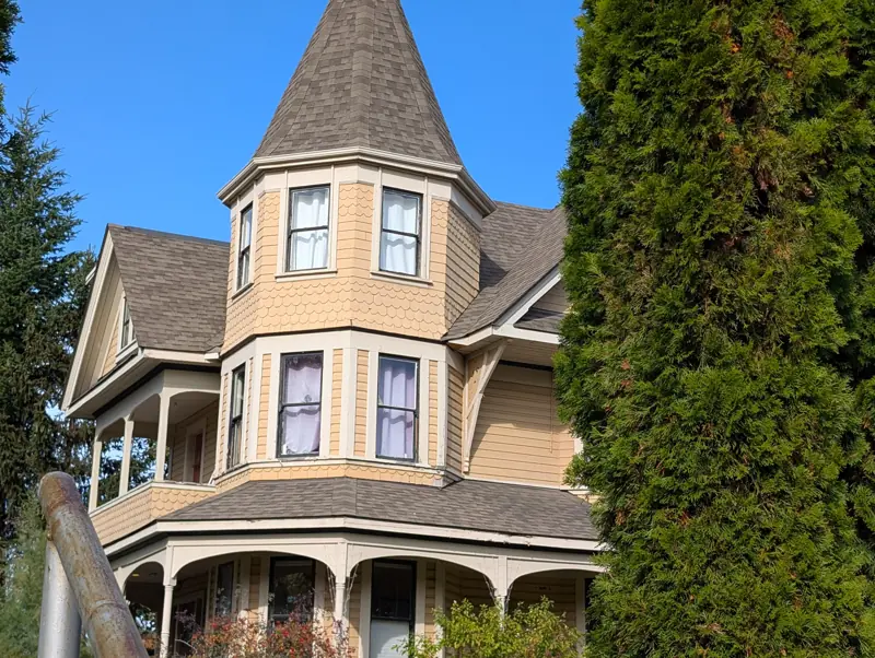 The octagonal tower, fish-scale shingles and wrap-around veranda