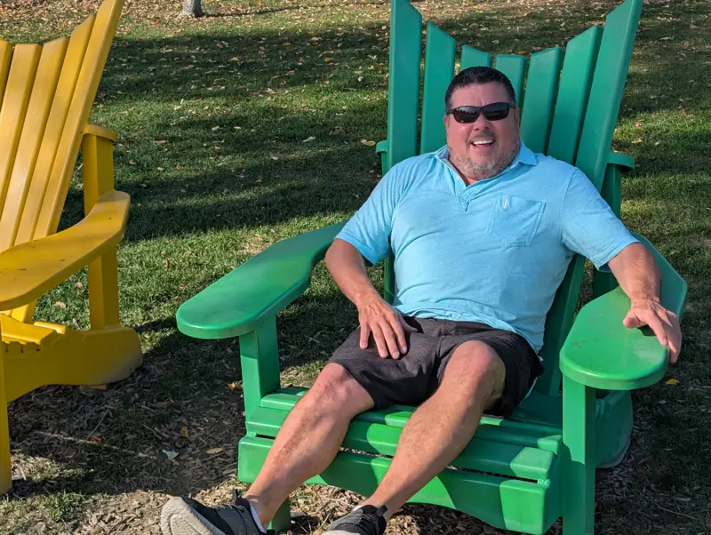 Tim Jones in one of the giant Muskoka chairs at Lakeview Park