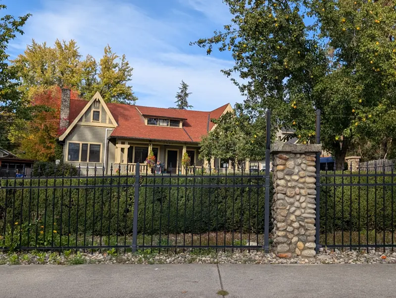 Fieldstone gateposts and iron fence on 23rd Avenue